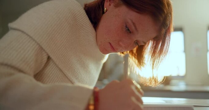 High school, girl and writing in exam with scholarship, thinking and ideas in classroom, student and education. Female person, teenager and remember in learning, development with confident in academy
