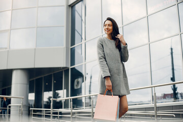 Cute girl with shopping bag in a city