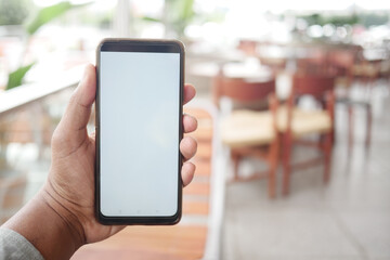 young man hand using smart phone with white screen at cafe 