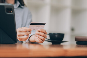 Happy asian woman using smartphone shopping online with credit card. Lifestyle. Easy pay using smart phone or digital device.