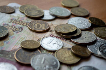 Russian currency, coins, banknotes lie on a wooden surface