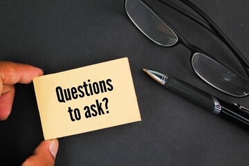 glasses, pen and paper with the words Questions to ask