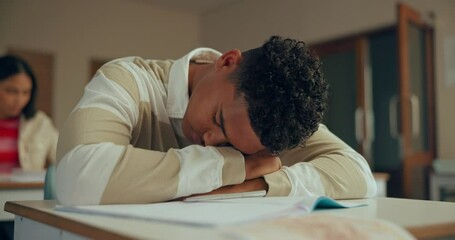 High school, burnout or tired boy sleeping n classroom with fatigue, risk or exhausted by studying pressure. Education, learning or bored gen z student with desk nap, dreaming or test, exam or stress