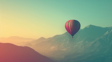 Fototapeta premium Serene sunrise scene with a colorful hot air balloon floating over misty mountains, capturing the essence of adventure and tranquility.