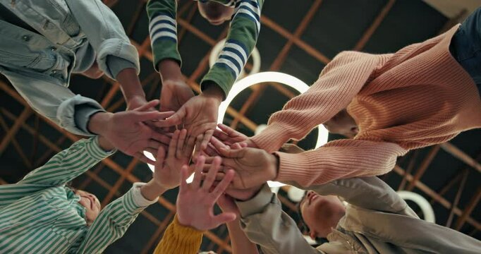 Students, stack and hands for education, teamwork and collaboration for solidarity in school. Teenagers, diversity and equality for learning, cheering and support with cooperation by lower angle