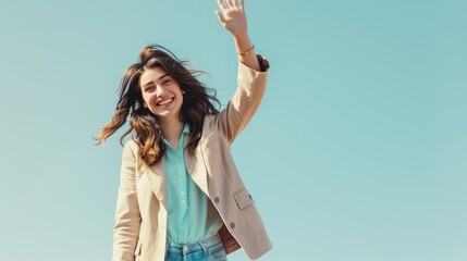Naklejka premium smiling young woman in a stylish blazer and jeans, waving hello with confidence, isolated on a plain, pastel background.