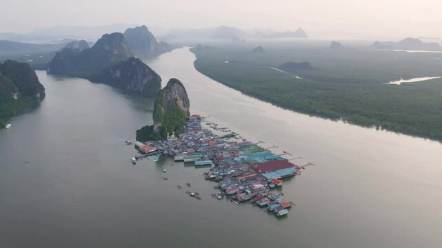 Aerial view of Koh Panyee, The Floating village urban city town houses, lake sea or river. Nature landscape fisheries and fishing tools at Pak Pha, Phang Nga, Thailand. Aquaculture farming