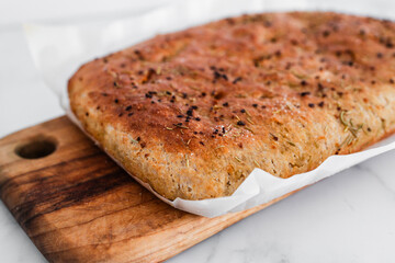 freshly baked focaccia bread with rosemary and salt flakes