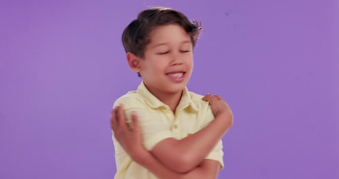 Happy, kid and care with hug in studio for self love, acceptance and kindness on purple background. Adorable, little boy and smile with gesture of embrace for development, growth and childhood