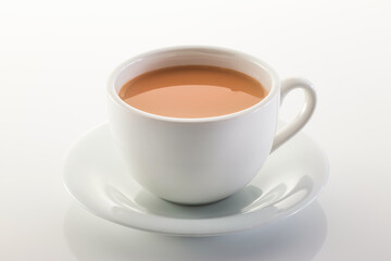Hot milk tea ir chai served in cup isolated on grey background side view of chinese hot drink