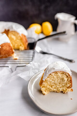 Lemon bundt cake with icing on a white plate