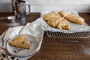 Freshly baked scones on a cooling rack, rustic kitchen setting