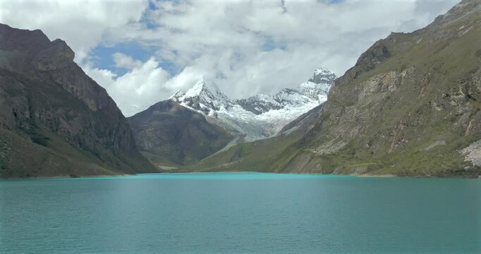 Turquoise waters of Paron lake surrounded by rugged Andean mountains