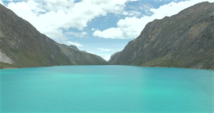Turquoise waters of Paron lake surrounded by rugged Andean mountains
