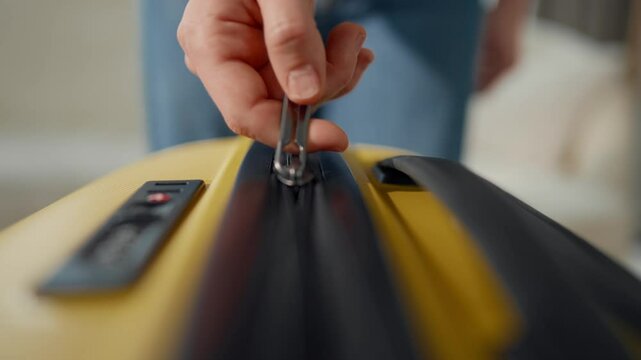 Woman hand zipping suitcase, closeup, slow motion, trip and travel concept. Person preparing to voyage in summer vacation or weekend trip, tourism and travelling. Move to other apartment, closing bag