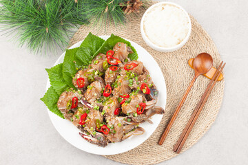  A food made by boiling ingredients such as onions and peppers, then pouring the cooled soy sauce over prepared crabs several times and allowing them to age.
