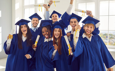 Group of excited smiling happy multiracial international graduates students having fun in a...