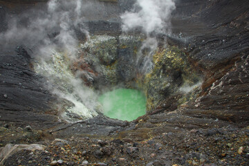 Acidic lake and fumes inside of a volcano crater © Vladimir