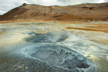 Geothermal spot and bubbling pools of mud & steaming fumaroles emitting sulfuric gas