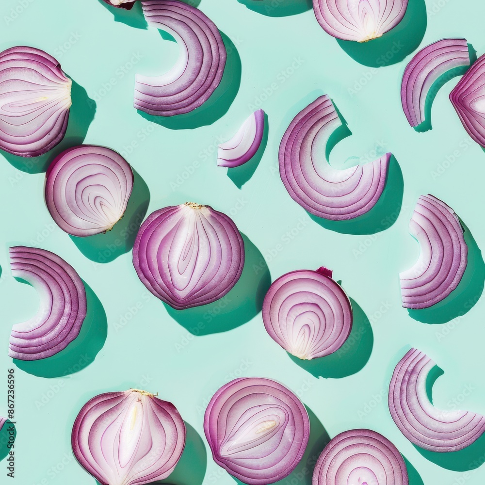 Wall mural onion slices and whole, shot from above, making a fun pattern on a bright pastel color background, m