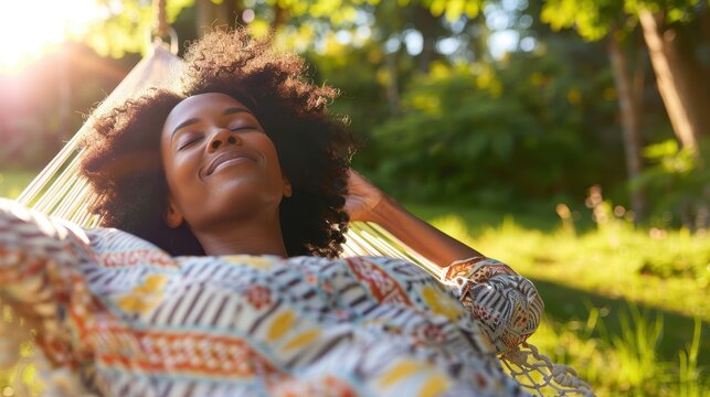 A woman is relaxing in a hammock outside on a sunny day