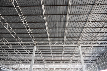 A large, empty building with a gray roof