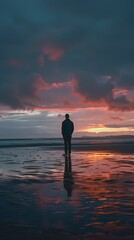 Image of a person on the beach at sunset