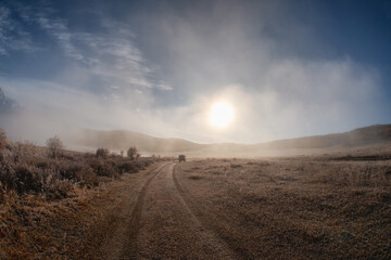 The road in the dry steppe in Altai region at dawn.