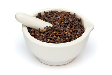 Close-up of Dry Organic Clove (Syzygium aromaticum) or Indian long, in white ceramic mortar and pestle, isolated on a white background.