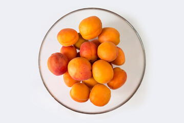 ripe apricots in a glass bowl