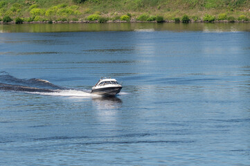 Motor boat goes fast on water.