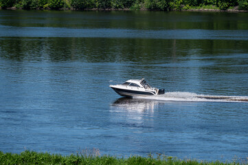 Fototapeta premium Motor boat goes fast on water.