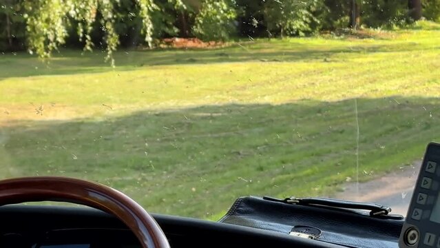 Travelling in Lithuanian countryside by coach, riding a bus past village, no people, nobody.