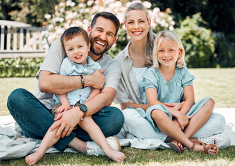 Fototapeta premium Portrait, family and grass for picnic, hug and outdoor to relax in summer, love and bonding in break. Parents, woman and man with children, happy and weekend for connecting with young kids in park
