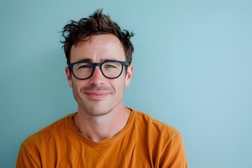 Obraz premium Smiling Man in Glasses Poses for Studio Photos