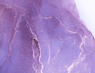 A close-up abstract image of purple and white ink swirling and merging on a white background