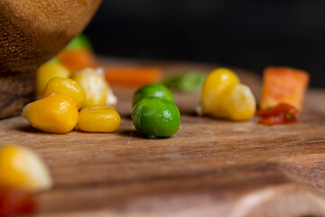 a mixture of quick-frozen corn, peas, peppers, and carrots