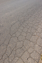 Obraz premium a part of a highway covered with cracked asphalt