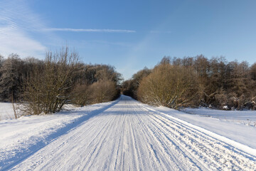 a road covered with snow that is dangerous for motor vehicles