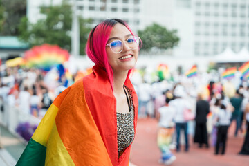 Celebrate in pride month festival. Pride movement transgender asian lesbian LGBT holding rainbow flag for freedom. Gatherings of friends in parade communities celebrating LGBTQ+ causes.