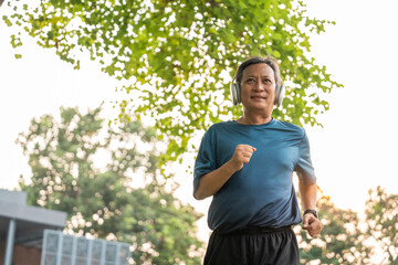 Senior old man runner exercise outdoor nature park. fitness man jogging wearing sportswear. Mature athlete man in sportswear Workout running at public park. Health and activity old man lifestyle