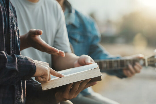 Christian Bible Study Concepts. Christian friend groups read and study the bible together in the park. sharing the gospel with a friend. followers are learning the word of God. praying to God.