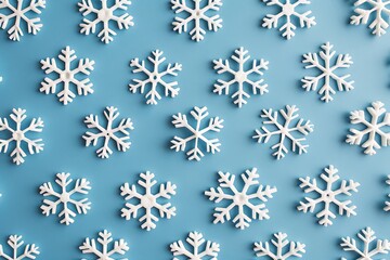 Fototapeta premium A pattern of minimalist, white snowflakes on a cool blue background
