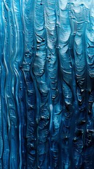 Blue paint flows and mixes, creating a vibrant abstract texture with bright and dark hues blending together