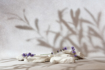 Beauty cosmetics product presentation mockup scene with copy space made with white stones and lavender flower. Composition aims to emphasize the natural purity and summer mood. Studio photography. © Dmytro