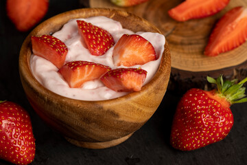 yogurt made from milk with added flavor and pieces of ripe strawberries