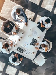 Top view of group of multiethnic busy people working in an office, Aerial view with businessman and businesswoman sitting around a conference table with blank copy space, Business meeting concept 