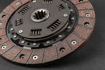 car clutch disc on a black background, auto transmission element, close-up