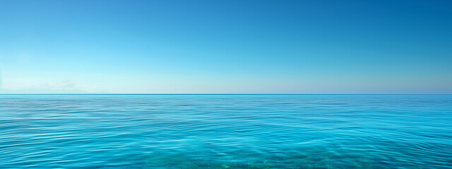 Obraz premium ocean horizon over calm clear blue sea water with cloudy blue sky