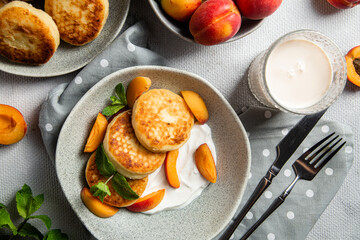 Cottage cheese pancakes with sour cream and apricots